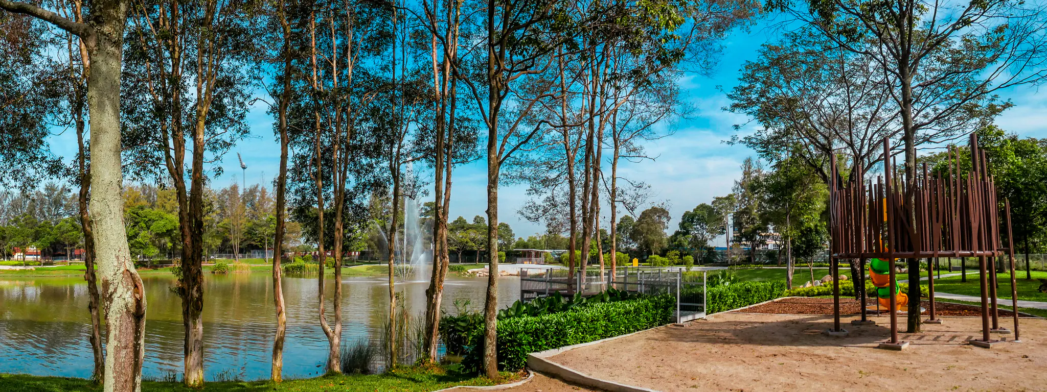 Tree-lined lakeside park with a fountain